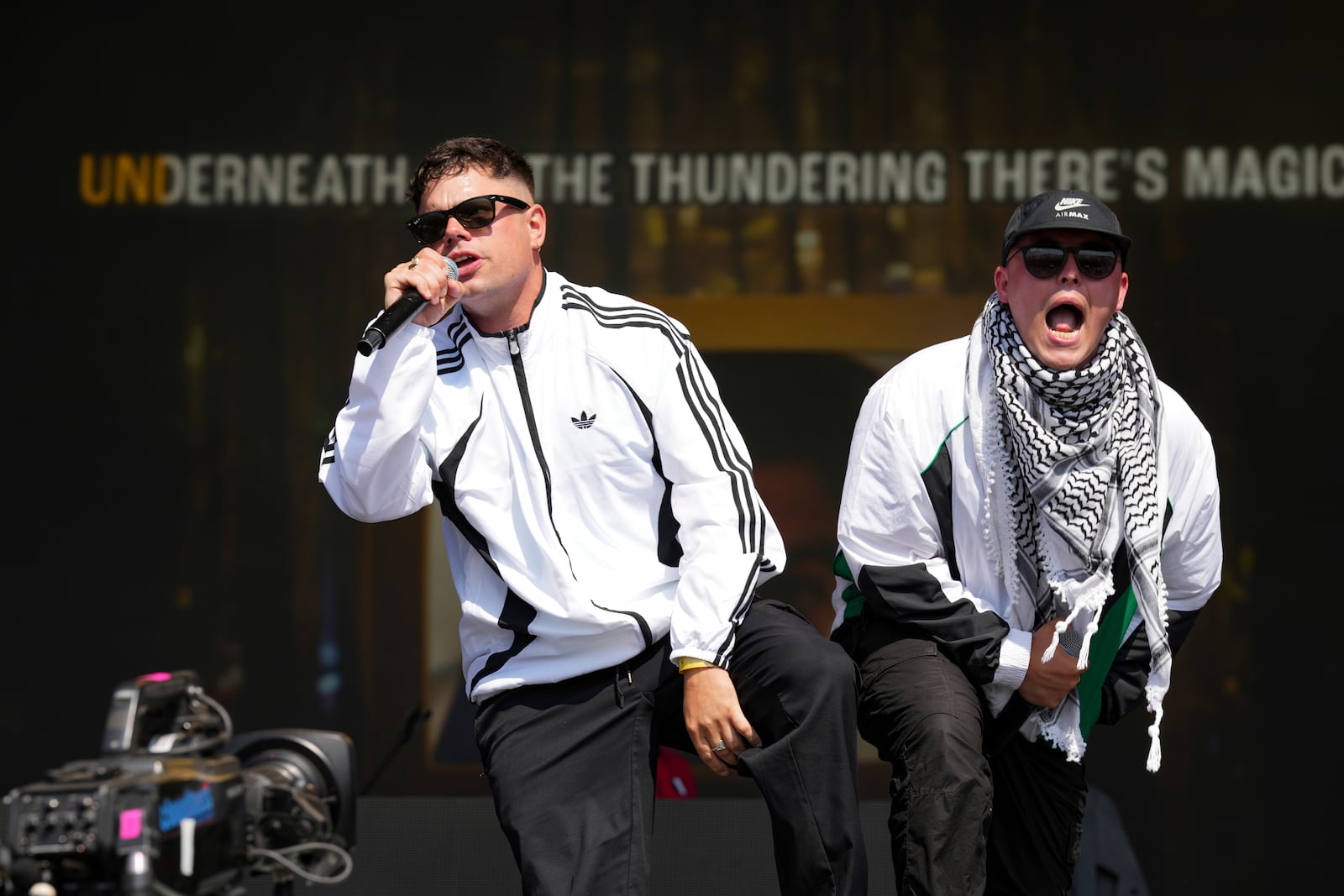 Naoise O Caireallain, left, and Liam Og of the hip hop trio Kneecap perform during the Glastonbury Festival in Worthy Farm, Somerset, England, Saturday, June 28, 2025. (Scott A Garfitt/Invision/AP)