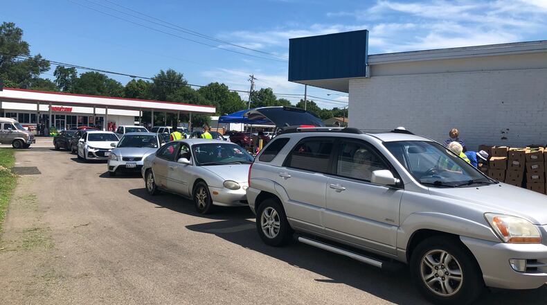 The Village Food Pantry in New Miami has served more clients since moving to a new location and after the coronavirus caused financial stress. RICK McCRABB/STAFF
