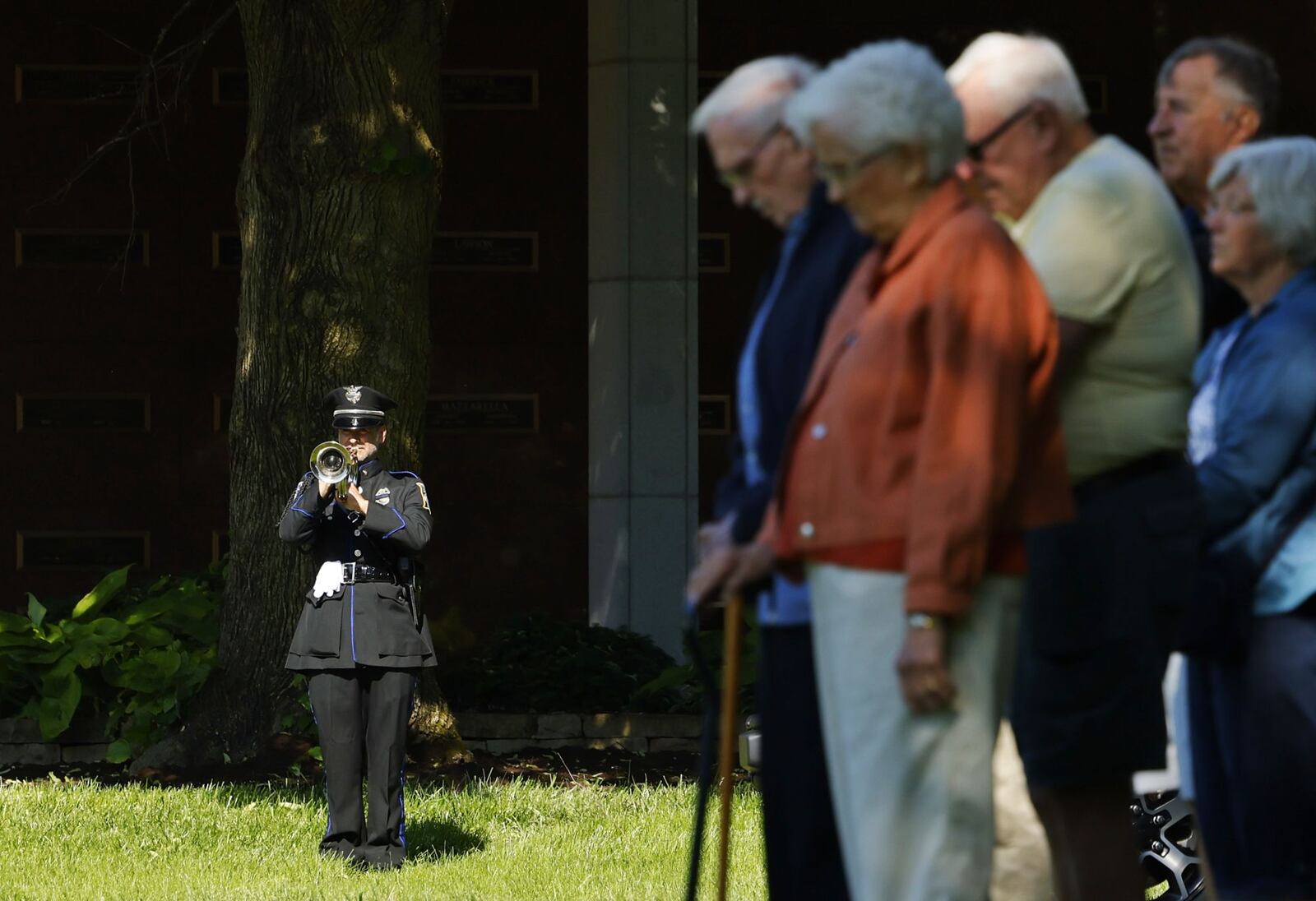 Middletown Police officer Andrew Minic plays "Taps" during a memorial ceremony for fallen officers Thursday, May 16, 2014 at Woodside Cemetery and Arboretum in Middletown. NICK GRAHAM/STAFF