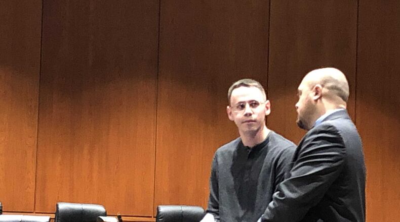 Samuel Ronan discusses terms of his sentence on Thursday with lawyer James Calhoun in Warren County Common Pleas Court. STAFF/LAWRENCE BUDD