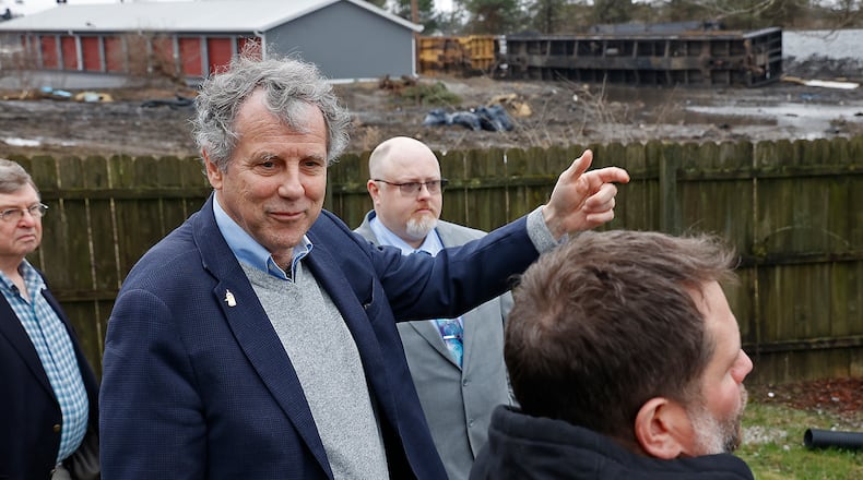 Sen. Sherrod Brown talks to Clark County business owner Lane Martin Friday, March 24, 2023 about the train derailment that occurred earlier this month next to his business. BILL LACKEY/STAFF