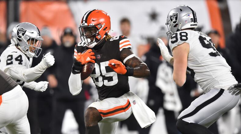 Cleveland Browns tight end David Njoku (85) runs against Las Vegas Raiders safety Johnathan Abram (24) and defensive end Maxx Crosby (98) after a catch during the second half of an NFL football game, Monday, Dec. 20, 2021, in Cleveland. (AP Photo/David Richard)