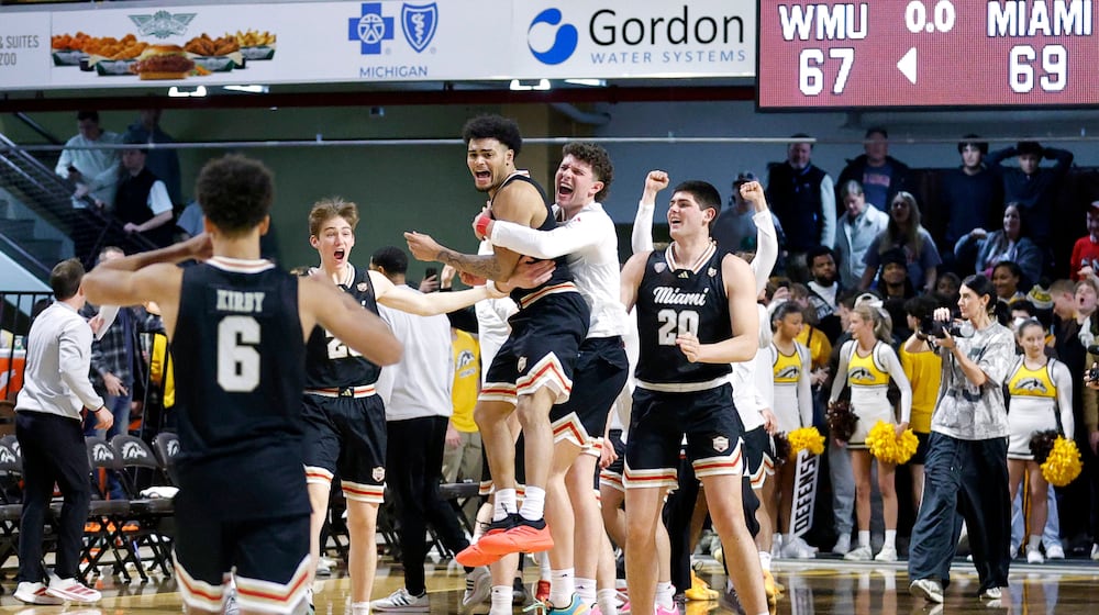 Miami (Ohio) players, including guard Trey Perry, center left, celebrate after Perry hit the game-winning shot against Western Michigan during the second half of an NCAA college basketball game, Friday, Feb. 27, 2026, in Kalamazoo, Mich. (AP Photo/Al Goldis)