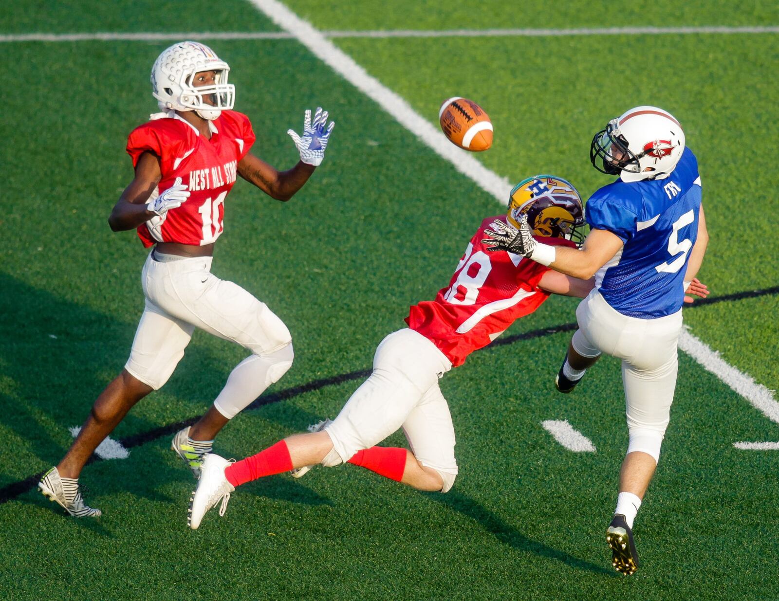 The West’s Ethan Minges (28) of Ross interrupts a pass intended for the East’s Dylan Fry (5) of Lakota East during the 43rd Southwestern Ohio Football Coaches Association Ron Woyan East-West All-Star Game on Thursday night at Kings. NICK GRAHAM/STAFF