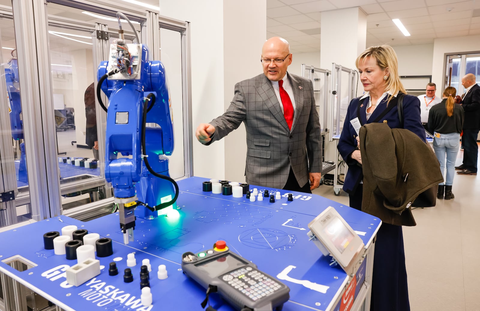 Miami University President Greg Crawford, left, shows Mary Schell, Chair of Miami University Board of Trustees, the robotics lab during a ribbon cutting and tour of the new Advanced Manufacturing Workforce and Innovation Hub Monday, Feb. 2, 2026 in Hamilton. The facility is a partnership between Miami University and Butler Tech in the former VORA Technology Park. NICK GRAHAM/STAFF