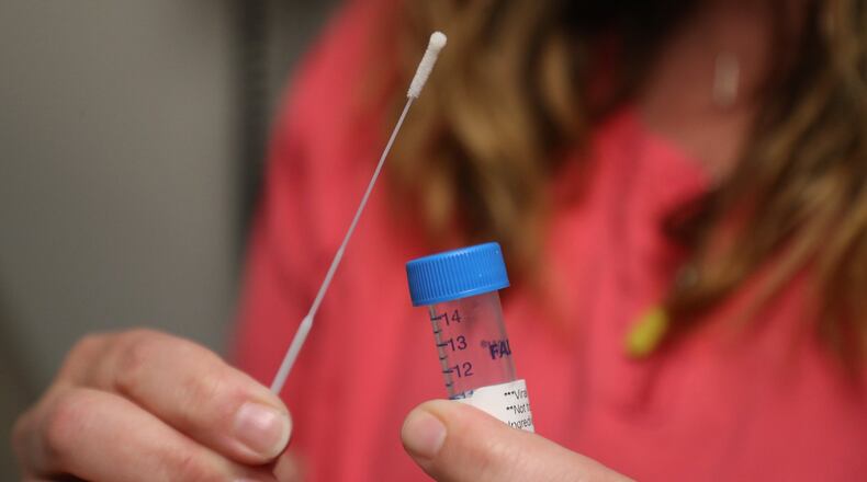 Lisa Saunders, Director of Quality and a RN at the Rocking Horse Center, shows an example of a Covid-19 tests. BILL LACKEY/STAFF