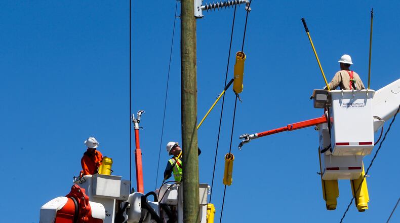 Duke Energy workers are investigating a power outage today. FILE/GREG LYNCH