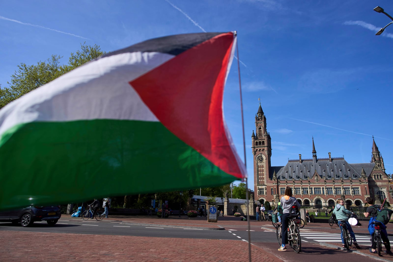 A Palestinian flag flies outside the International Court of Justice, rear, which opened hearings into a United Nations request for an advisory opinion on Israel's obligations to allow humanitarian assistance in Gaza and the West Bank, in The Hague, Netherlands, Monday, April 28, 2025. (AP Photo/Peter Dejong)