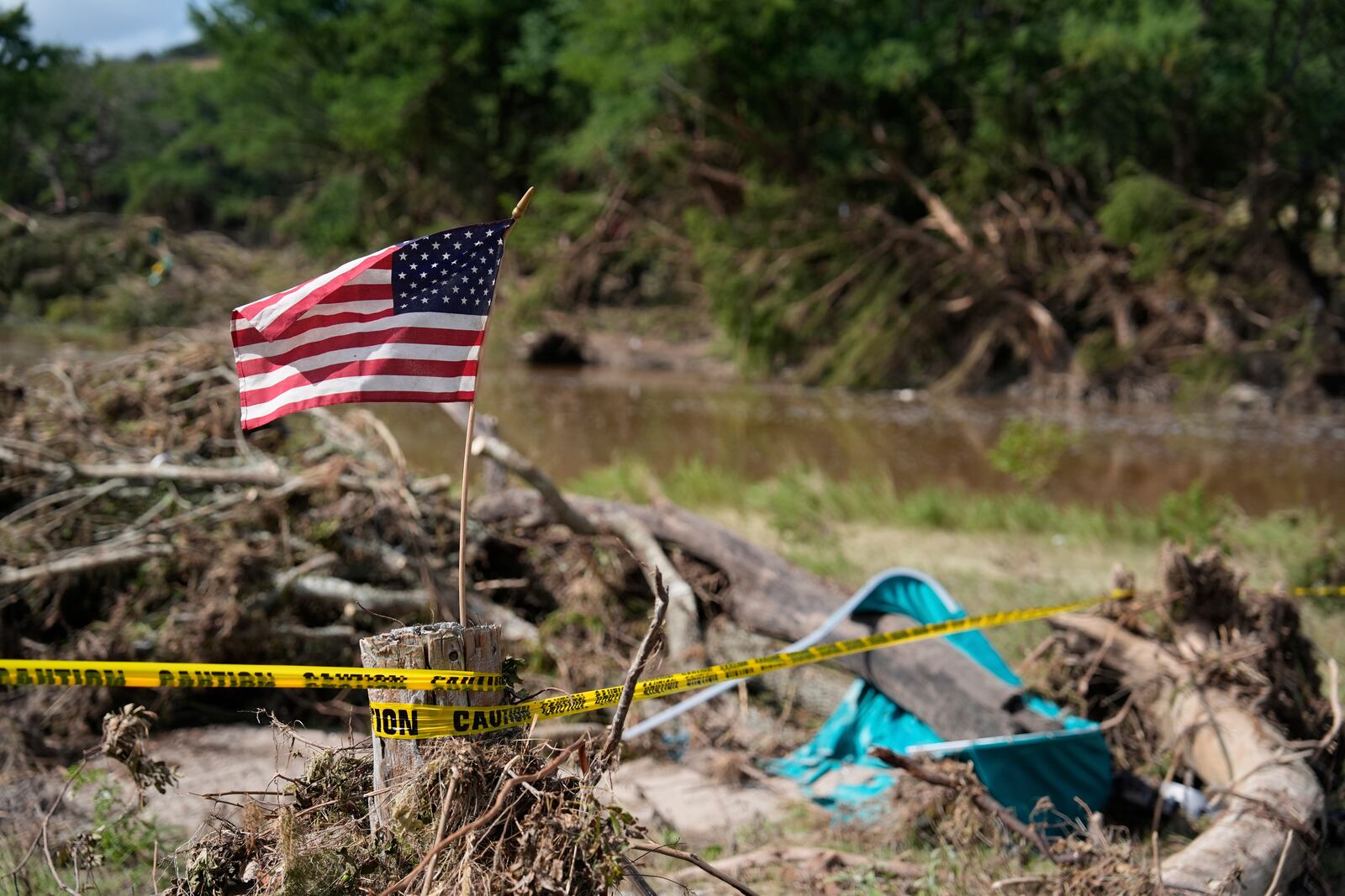 FILE - An American flag is placed on a stump flies in Kerrville, Texas on July 8, 2025. (AP Photo/Ashley Landis, file)