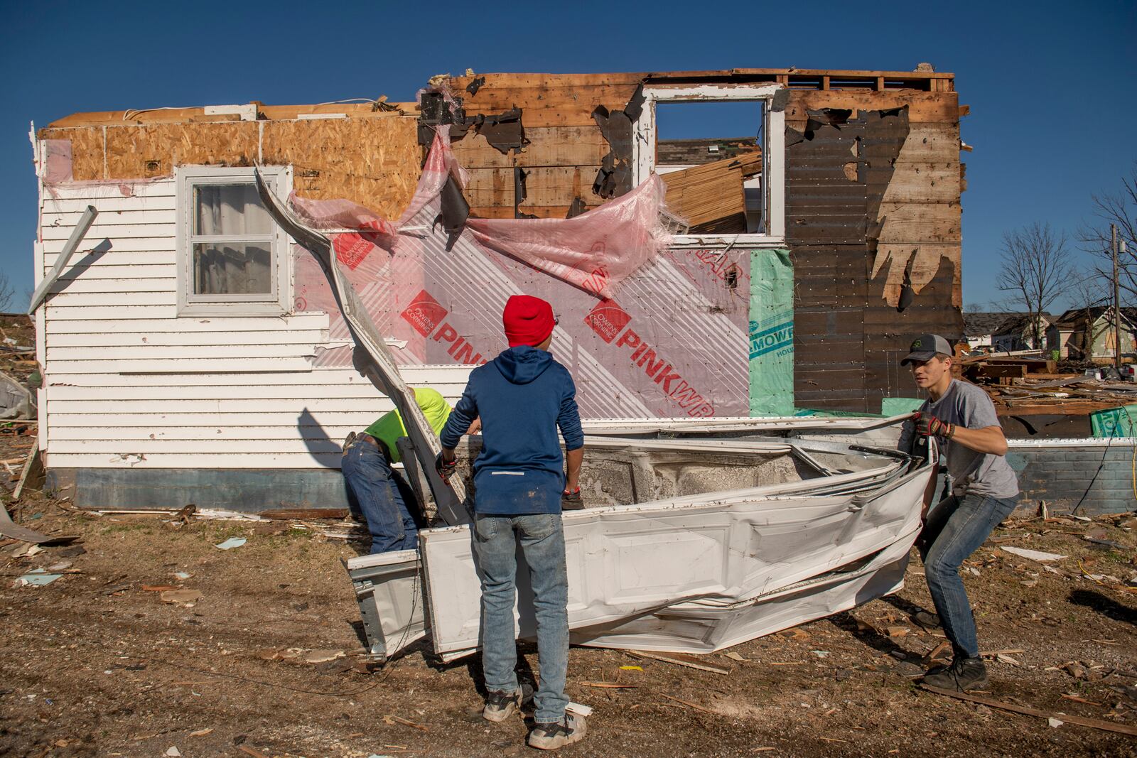 Volunteers help with the cleanup efforts in Mayfield, Ky. on Monday, Dec. 13, 2021, after a tornado swept across the region. Determining how many people died in the tornadoes that ravaged the central U.S. on Friday has been a challenging task so far, with estimates fluctuating as search teams continue to spread out amid vast fields of rubble in an effort to rescue the living and account for the dead.(Johnny Milano/The New York Times)