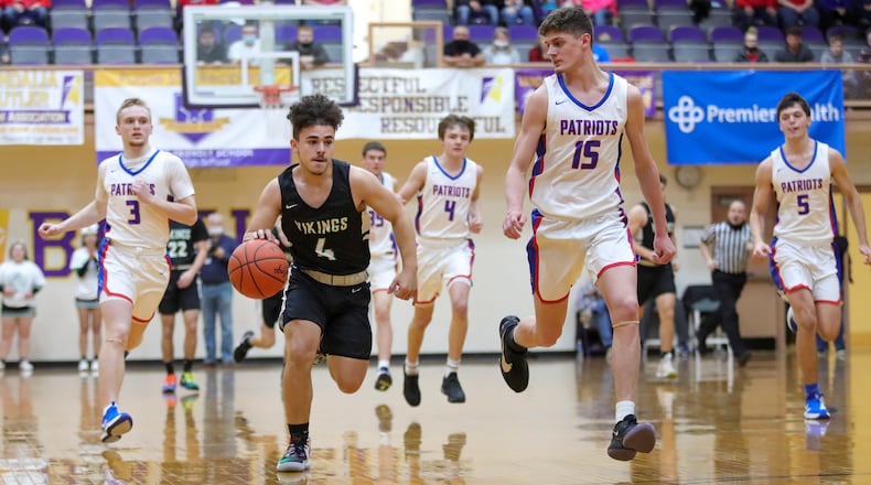 New Miami's Deanza Duncan drives past Tri-Village's Layne Sarver 
during their D-IV district final game on Saturday afternoon at the Vandalia Butler Student Activity Center. The Patriots won 61-39. Michael Cooper/CONTRIBUTED