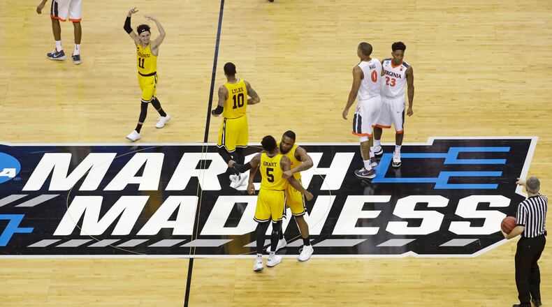 FILE - UMBC players celebrate their 74-54 win over Virginia in a first-round game in the NCAA men's college basketball tournament in Charlotte, N.C., March 16, 2018. Five years ago Thursday a tiny school few had ever heard of — and virtually no one gave an ounce of a chance to win — pulled off the biggest upset in NCAA Tournament history as University of Maryland-Baltimore County knocked off the tournament’s top overall seed, elevating March Madness to a whole new level. (AP Photo/Chuck Burton, File)