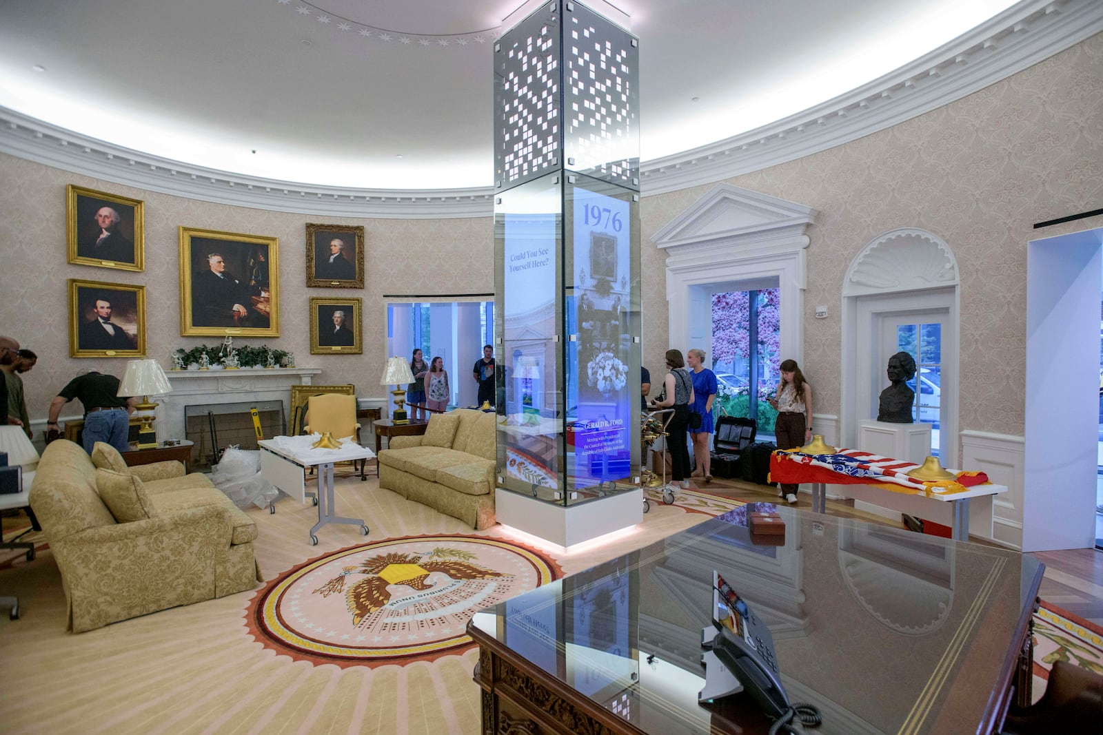 People work during an effort to transition a replica of the White House Oval Office from the days of former President Joe Biden with President Donald Trump's decor, at the White House Historical Association in Washington, Wednesday, July 23, 2025. (AP Photo/Rod Lamkey, Jr.)