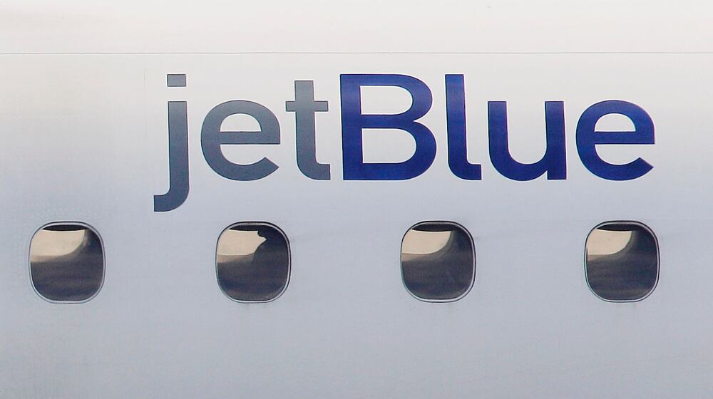 FILE - A JetBlue logo is displayed on the side of a jet as it taxis at Boston's Logan International Airport, Jan. 20, 2011. (AP Photo/Stephan Savoia, File)