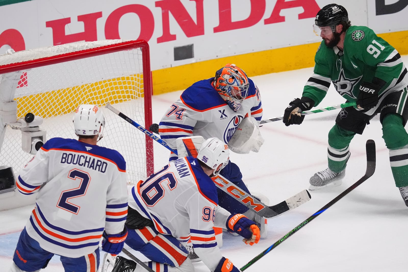 Dallas Stars center Tyler Seguin (91) scores a goal against Edmonton Oilers goaltender Stuart Skinner (74), defensemen Jake Walman (96) and Evan Bouchard (2) during the third period in Game 1 of the Western Conference finals in the NHL hockey Stanley Cup playoffs Wednesday, May 21, 2025, in Dallas. (AP Photo/LM Otero)