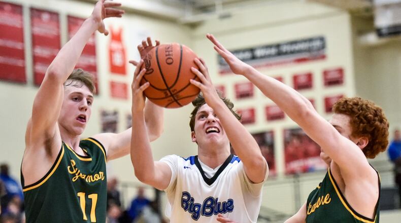 Hamilton’s Jackson Lewis drives to the basket defended by Sycamore’s Ben Yukewich (11) and Oliver Wittenbaum (1) Thursday night during their Division I sectional basketball game at Lakota West. Sycamore won 47-44. NICK GRAHAM/STAFF