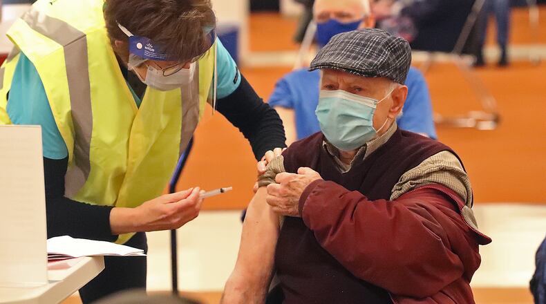 Charles Simpson gets his COVID vaccine shot Tuesday at the Clark County Combined Health District's COVID distribution center. BILL LACKEY/STAFF