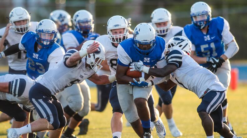 Hamilton quarterback Eric Jackson carries the ball during the first quarter of their game against Kettering Fairmont Friday, Sept. 2 at Hamilton High School in Hamilton. NICK GRAHAM/STAFF