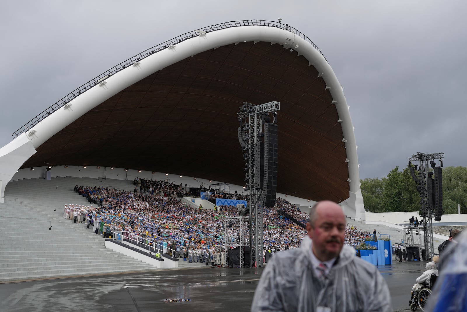 Choir singers attend the "Iseoma" Song and Dance Celebration at the Song Festival Grounds in Tallinn, Estonia, on Sunday, July 6, 2025. (AP Photo/Sergei Grits)