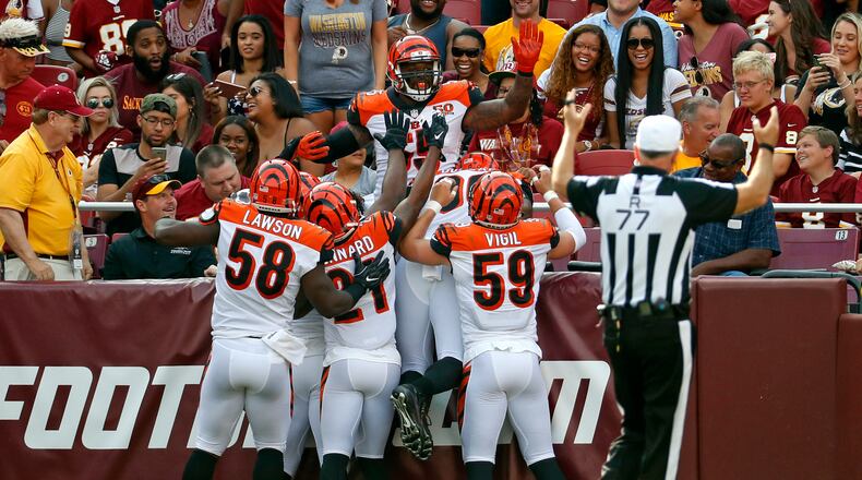 Cincinnati Bengals outside linebacker Vontaze Burfict, top, celebrates with teammates after intercepting a pass by Washington Redskins quarterback Kirk Cousins and scoring a touchdown in the first half of a preseason NFL football game, Sunday, Aug. 27, 2017, in Landover, Md. (AP Photo/Alex Brandon)