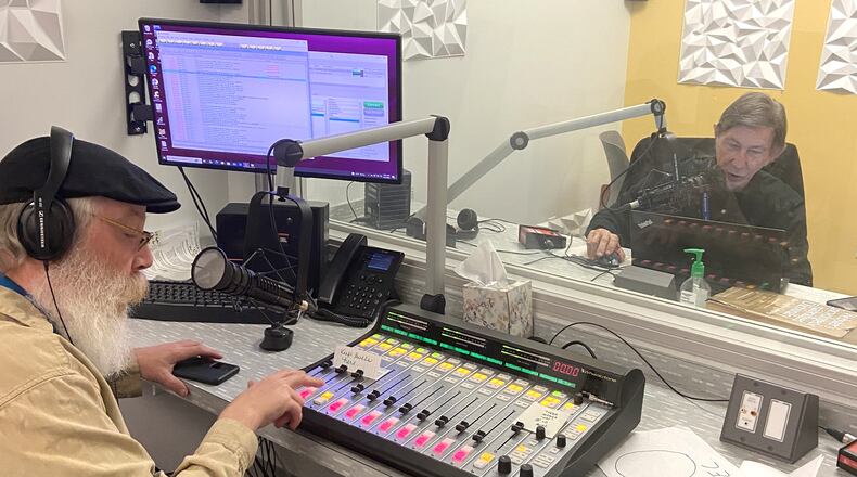 Volunteer Steve Popp (right) reads the Dayton Daily News while Eric Henry mans the control board at the Radio Reading Service studio in the Goodwill Easterseals Miami Valley building. CONTRIBUTED