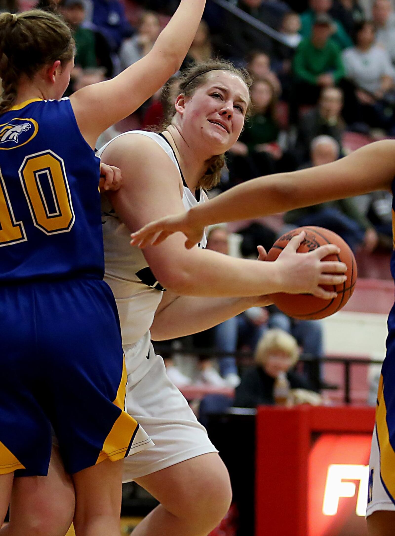 Badin forward Emma Broermann eyes the basket as Madeira’s Molly Buzek applies pressure Saturday afternoon during a Division III sectional final at Fairfield Arena. CONTRIBUTED PHOTO BY E.L. HUBBARD