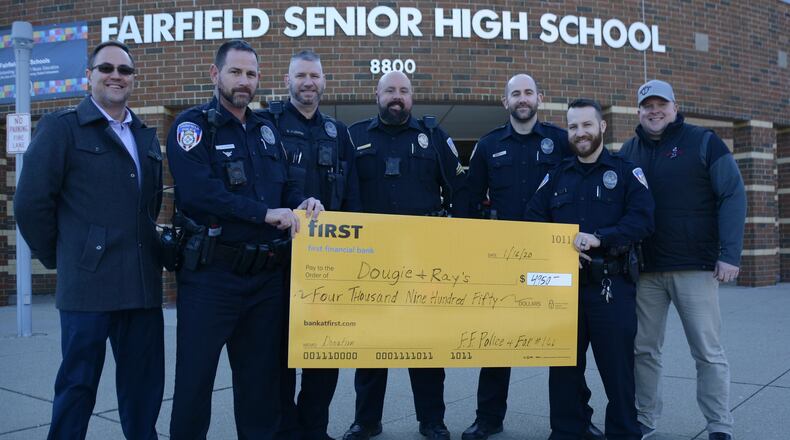 Fairfield police and the FOP Lodge 166 raised and donated $4,950 to Dougie and Ray’s, a charity that supports in-need children and families within the Fairfield School District. Pictured are Fairfield police Officers with Ted McDaniel, far right, the founder of Dougie and Ray’s, and Scott Clark, far left, a Dougie and Ray’s board member. MICHAEL D. PITMAN/STAFF