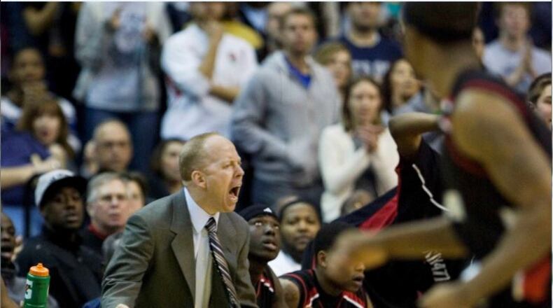 Cincinnati head coach Mick Cronin shouts instructions to his players during the overtime period of an NCAA basketball game against Georgetown, Saturday, Feb. 7, 2009, in Washington. The Bearcats won 64-62 in an overtime.