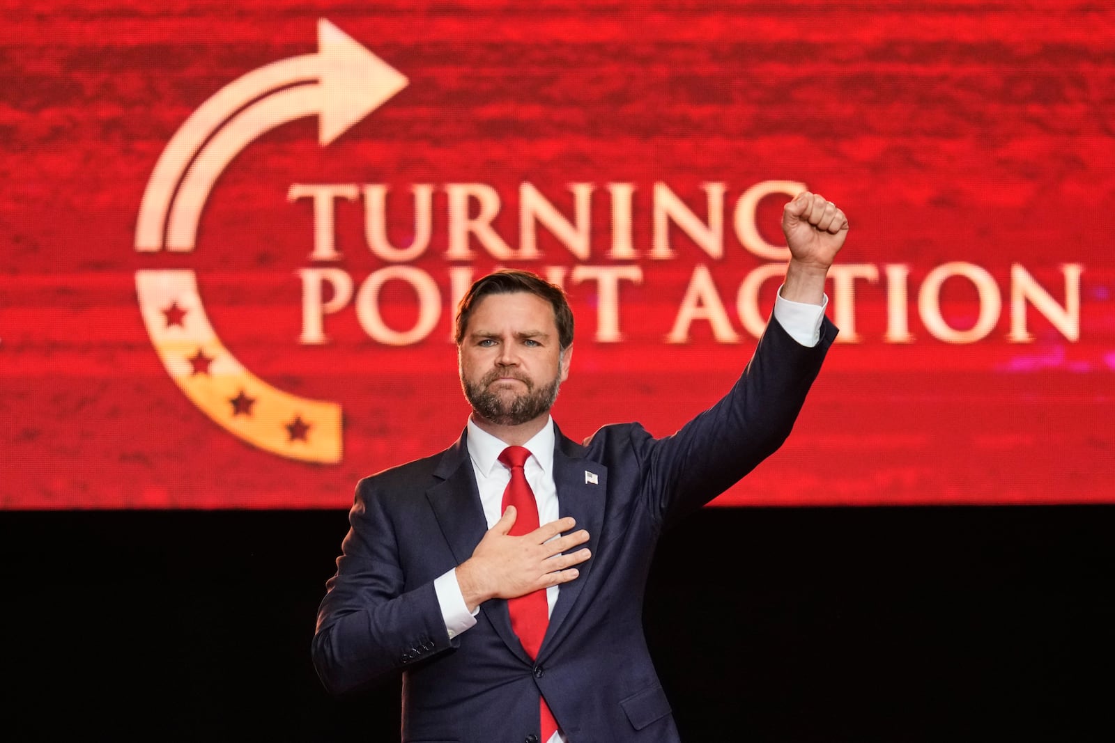 Vice President JD Vance holds his fist up as he leaves the stage after speaking at a memorial for conservative activist Charlie Kirk, Sunday, Sept. 21, 2025, at State Farm Stadium in Glendale, Ariz. (AP Photo/John Locher)