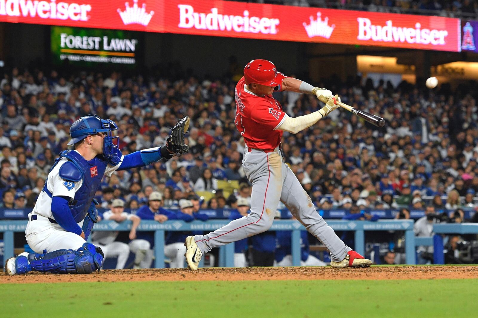 Los Angeles Angels' Logan O'Hoppe, hits a three-run home run as Los Angeles Dodgers catcher Dalton Rushing watches during the seventh inning of a baseball game Saturday, May 17, 2025, in Los Angeles. (AP Photo/Mark J. Terrill)