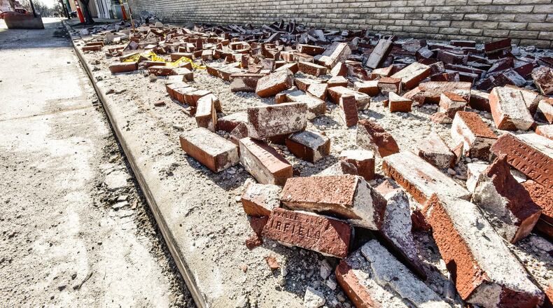 Recent high winds damaged part of the roof of the former Montgomery Ward building that is owned by the city of Middletown. The bricks and other debris that fell have been moved to the sidewalk and pulled back to the sidewalk, but city officials said they are moving ahead with demolition of the building located on North Main Street. The city has closed the southbound right lane of Main Street in front of the building. NICK GRAHAM / STAFF