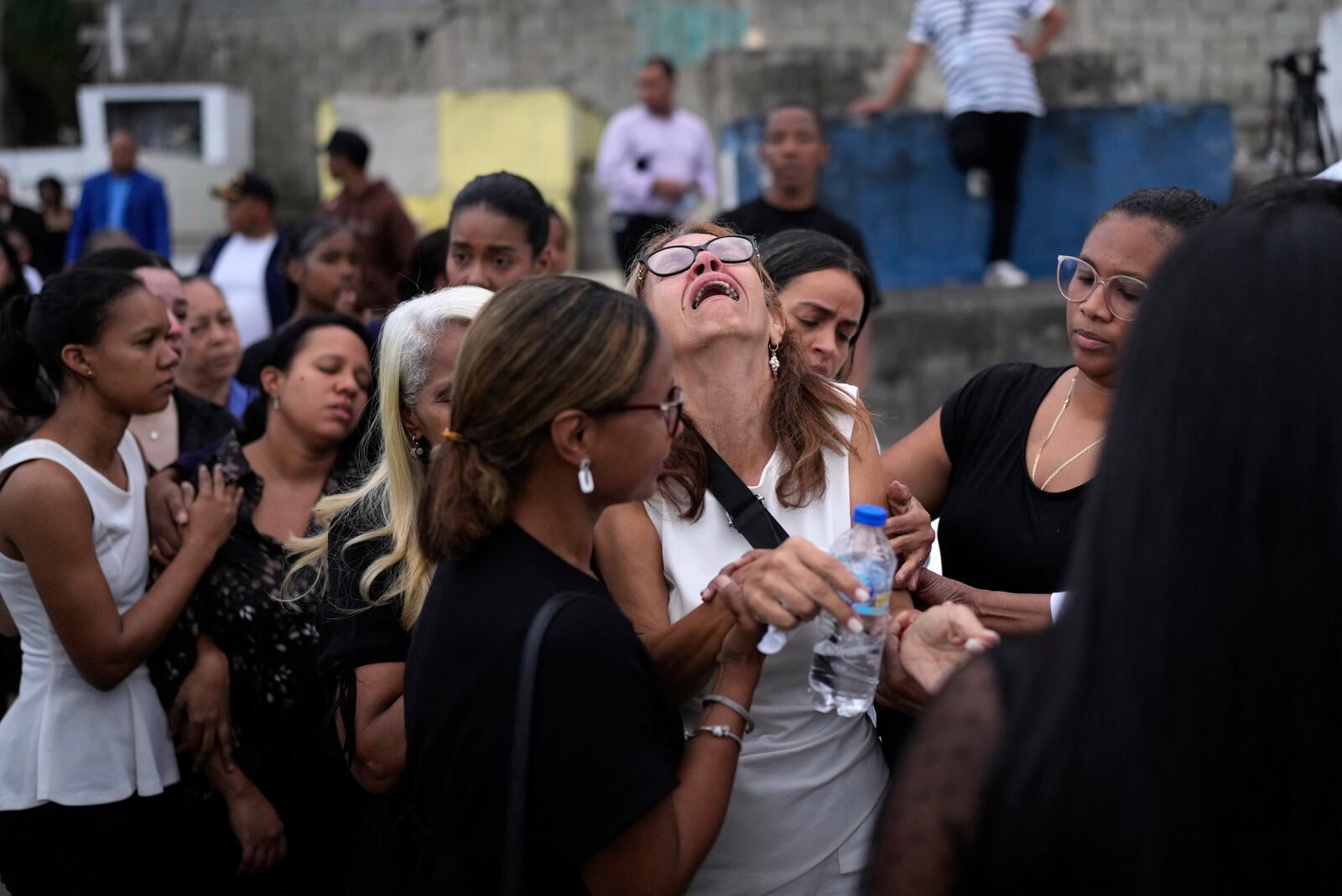 Family and friends grieve during the burial service for Marilenny Pilarte who died at the Jet Set nightclub when its roof collapsed, in Haina, Dominican Republic, Thursday, April 10, 2025. (AP Photo/Matias Delacroix)