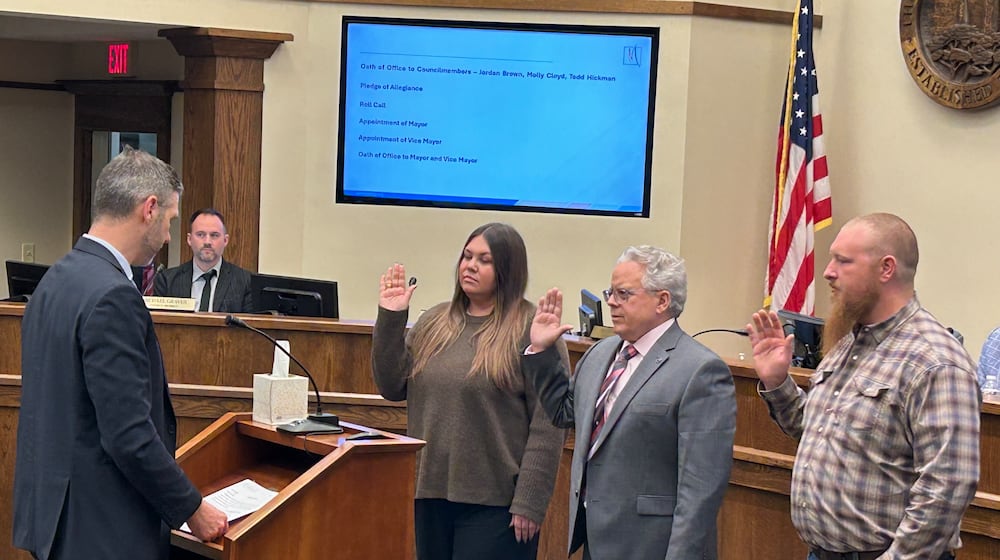Law Director Jack Hemenway II swears in the three new Monroe City Council members during Tuesday night's meeting. From left: Molly Cloyd, Todd Hickman and Jordan Brown. RICK McCRABB/CONTRIBUTED