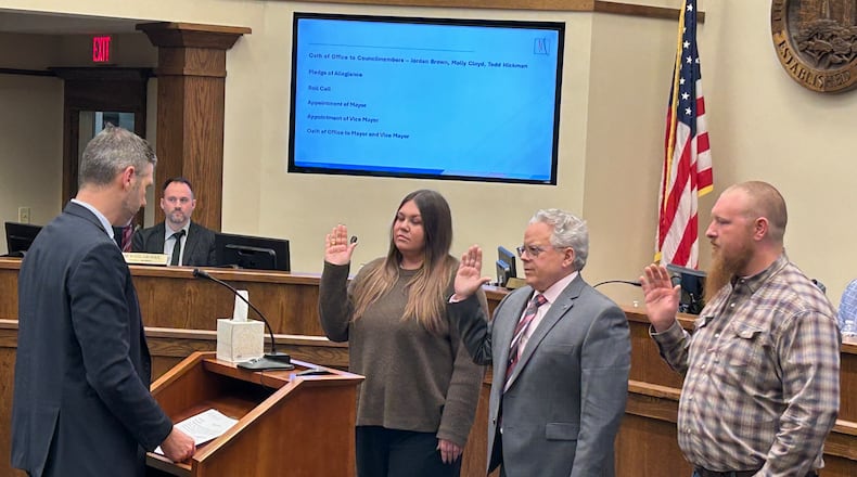 Law Director Jack Hemenway II swears in the three new Monroe City Council members during Tuesday night's meeting. From left: Molly Cloyd, Todd Hickman and Jordan Brown. RICK McCRABB/CONTRIBUTED