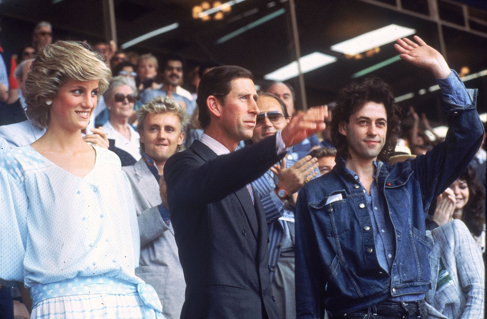 FILE - Princess Diana, left, and Prince Charles attend the Live Aid concert as they acknowledge the crowd with event organizer Bob Geldof, right, at London's Wembley Stadium, on July 13, 1985. (AP Photo/Joe Schaber, File)