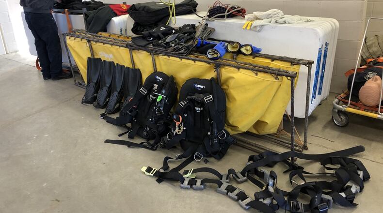 Turtlecreek Twp. Assistant Fire Chief Mike Jameson tending to dive gear used on Monday night to recover the horse drowned in a pond during a harness race at the Miami Valley Gaming racino. STAFF/LAWRENCE BUDD