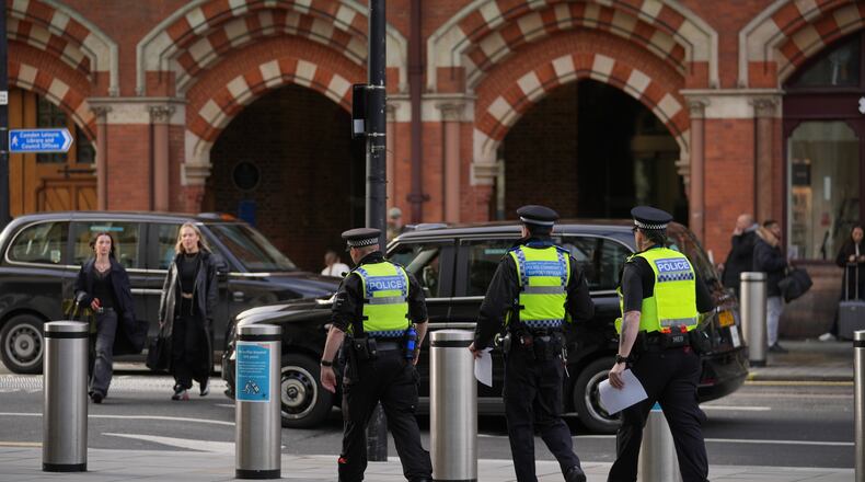 FILE - Police officers patrol the King's Cross train station, in London, Monday, Nov. 3, 2025. (AP Photo/Kin Cheung, File)