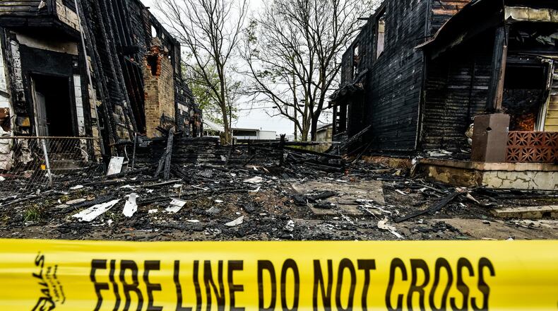 An early morning fire destroyed three homes in the 600 block of Ludlow street Wednesday, May 6, 2020 in Hamilton. NICK GRAHAM / STAFF