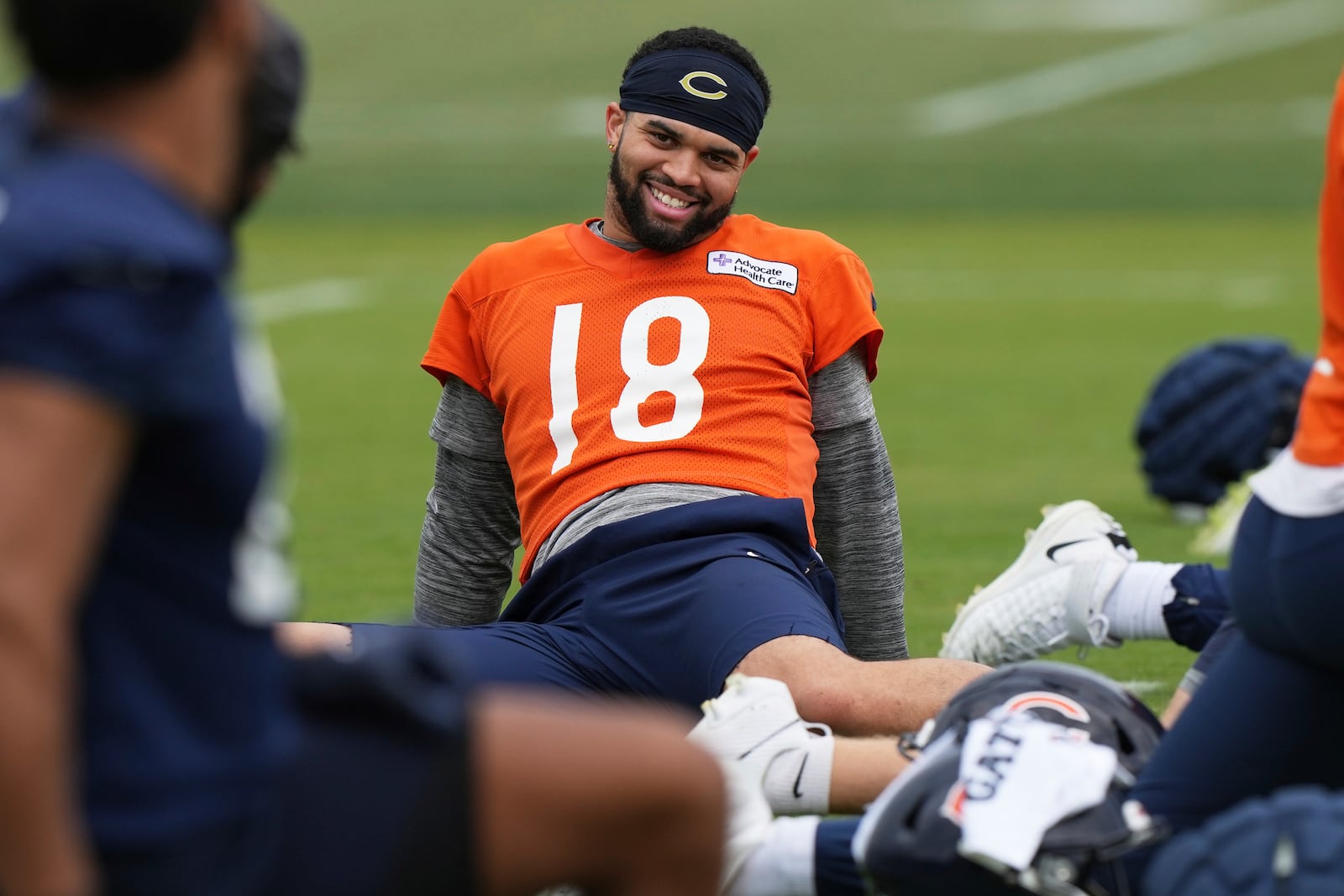 Chicago Bears quarterback Caleb Williams (18) smiles as he warms up during NFL football practice in Lake Forest, Ill., Wednesday, May 28, 2025. (AP Photo/Nam Y. Huh)