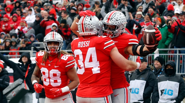 Ohio State tight end Cade Stover, right, celebrates one of his touchdowns against Indiana with teammate tight end Mitch Rossi, center, and tight end Gee Scott during the second half of an NCAA college football game Saturday, Nov. 12, 2022 in Columbus, Ohio. Ohio State won 56-14. (AP Photo/Paul Vernon)