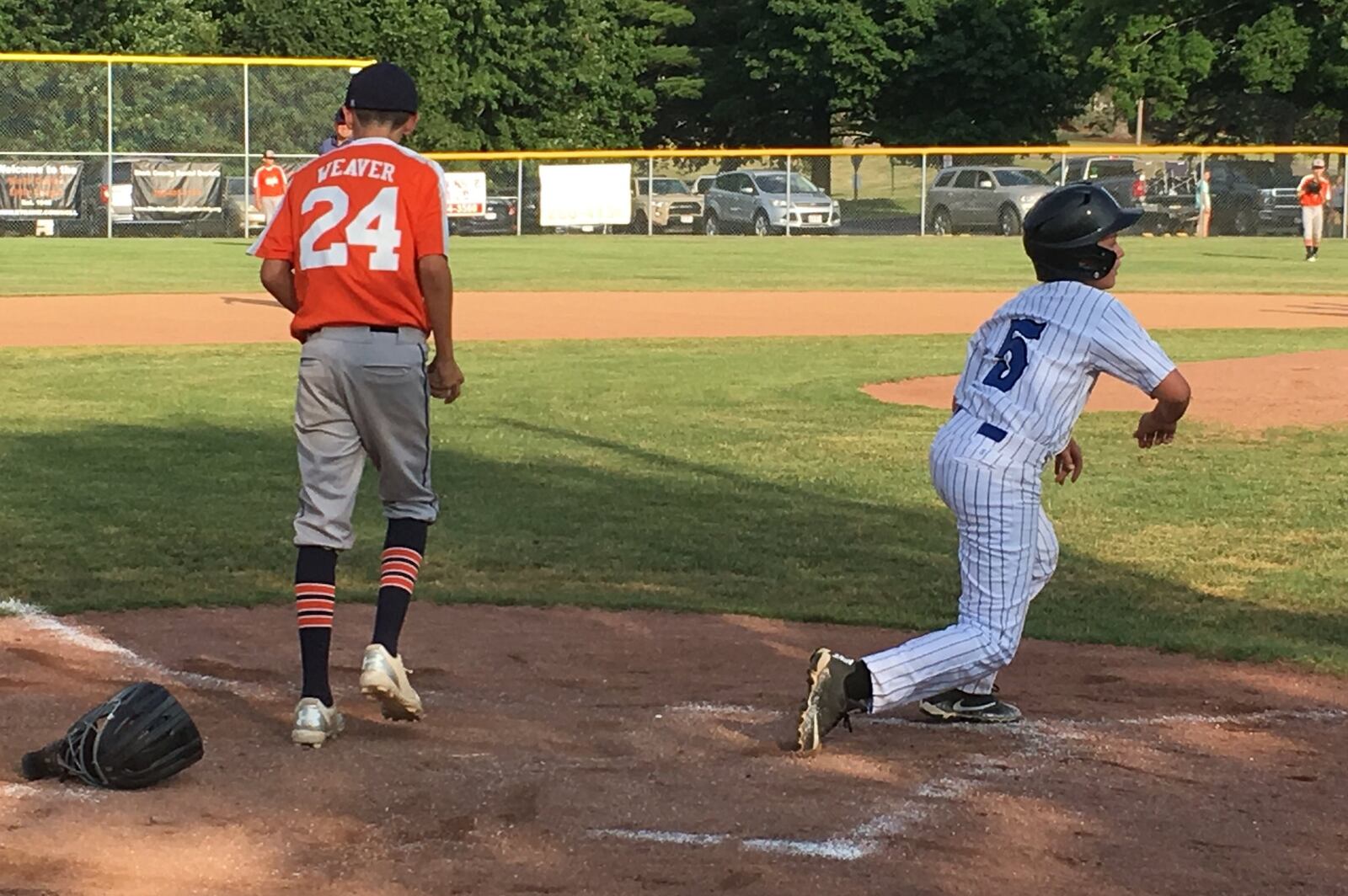 Hamilton West Side’s Jacob Baker reacts after scoring a run during Thursday night’s 15-1 triumph over Galion in the Ohio Little League Tournament at the Hoover Community Recreation Complex in North Canton. Galion’s Carter Weaver is also pictured. RICK CASSANO/STAFF