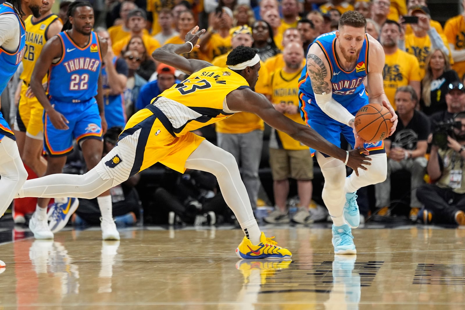 Oklahoma City Thunder center Isaiah Hartenstein (55) and Indiana Pacers forward Pascal Siakam (43) reach for the ball during the second half of Game 6 of the NBA Finals basketball series, Thursday, June 19, 2025, in Indianapolis. (AP Photo/Abbie Parr)
