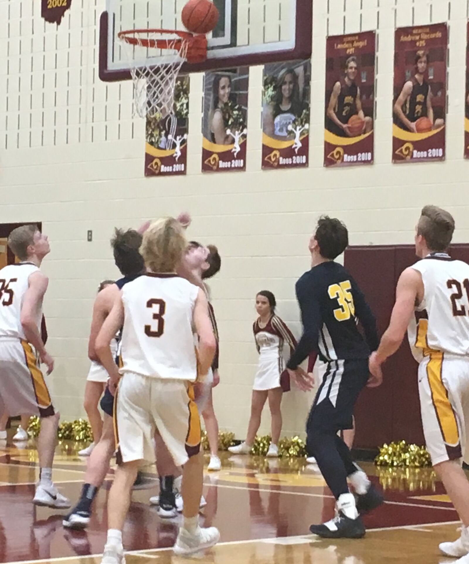 Cody Geers (35), Dylan Zimmerman (3) and Landen Angel (21) are among the Ross players waiting to see what’s going to happen with the ball Tuesday night at RHS. Also getting a good look is Monroe’s Caimanne Turner (35, blue jersey). RICK CASSANO/STAFF
