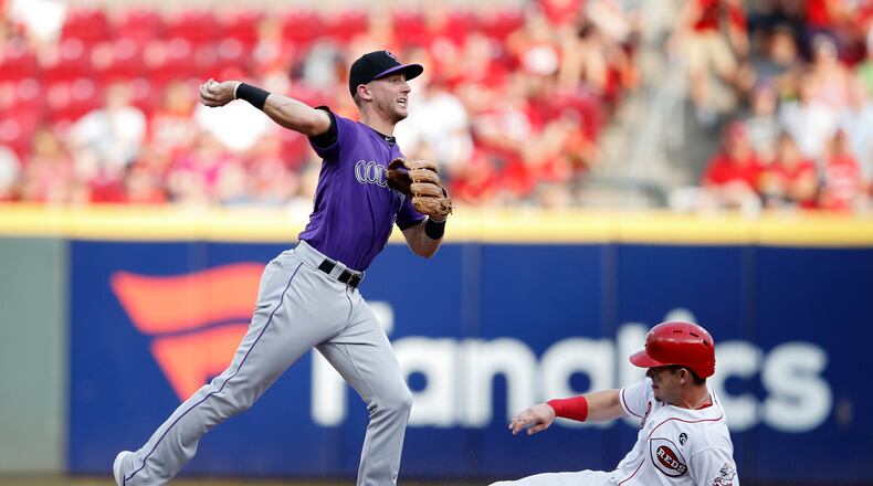 CINCINNATI, OH - JULY 26: Ryan McMahon #24 of the Colorado Rockies turns a double play ahead of the sliding Scooter Gennett #3 of the Cincinnati Reds in the second inning at Great American Ball Park on July 26, 2019 in Cincinnati, Ohio. (Photo by Joe Robbins/Getty Images)