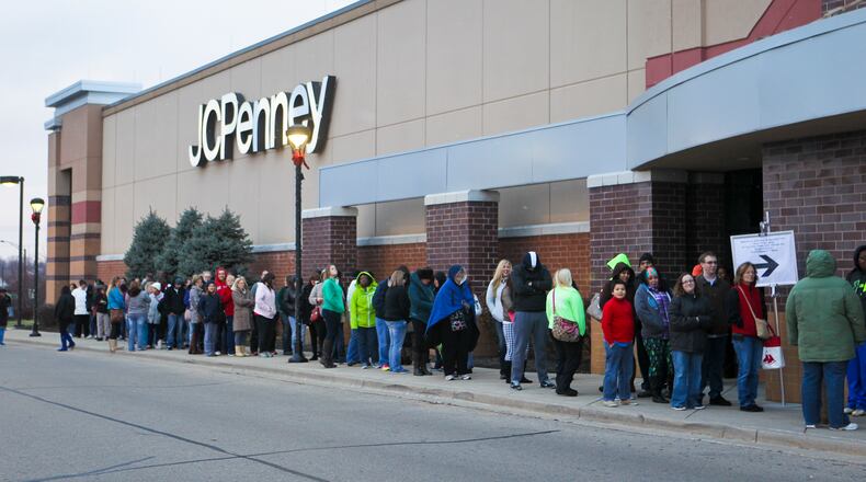 Holiday shoppers wait in line on Thanksgiving Day for early deals at JCPenney at the Bridgewater Falls shopping center, Thursday, Nov. 27, 2014. GREG LYNCH / STAFF