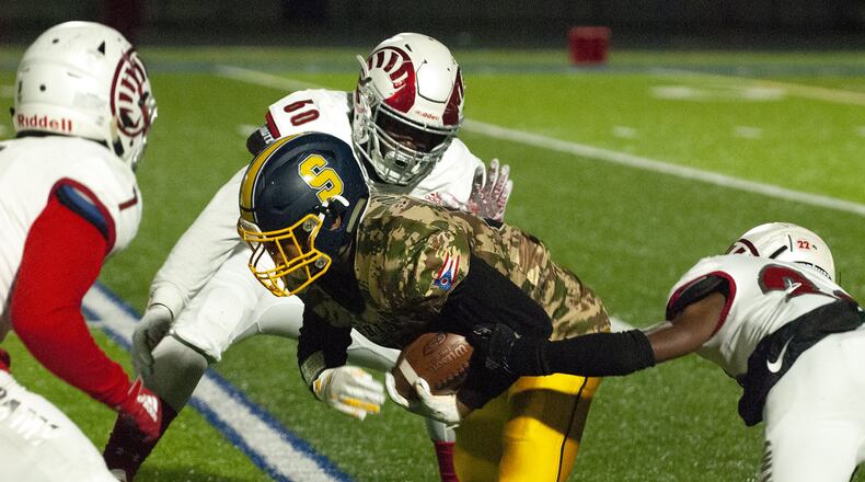 Springfield tailback Jeff Tolliver runs for yardage at Trotwood-Madison during the first half Friday, Nov. 1, at Springfield. Jeff Gilbert/CONTRIBUTED