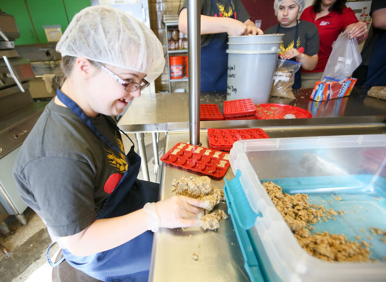 Gabby Jones uses a mold to form dog bones made out of spent beer hops. Project Life 101 is a transition program that helps students with disabilities learn real-world skills. 