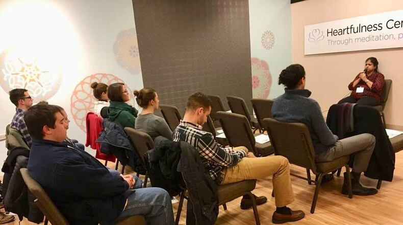 Uma Mullapudi leads a group into meditation at the Heartfulness Lounge at the Fairfield Commons Mall.