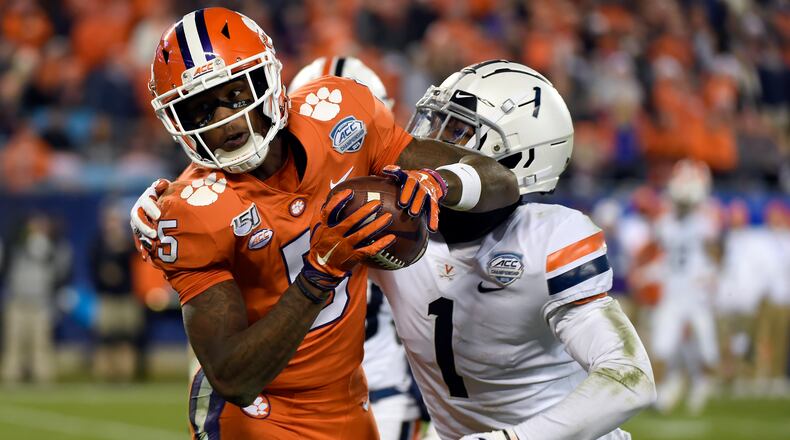 FILE - In this Dec. 7, 2019, file photo, Clemson wide receiver Tee Higgins (5) catches a pass while Virginia cornerback Nick Grant (1) defends during the second half of the Atlantic Coast Conference championship NCAA college football game in Charlotte, N.C. Higgins was selected by the Cincinnati Bengals in the second round of the NFL football draft Friday, April 24, 2020. (AP Photo/Mike McCarn, File)
