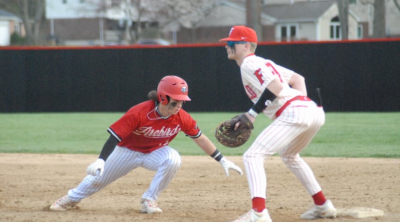 Fairfield first baseman Connor Raquet awaits a pickoff attempt as Lakota West base runner Adrian Smith dives back safely on Wednesday at Joe Nuxhall Field. Chris Vogt/CONTRIBUTED